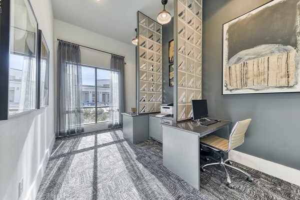 Business center featuring sleek workstations at Moderno Apartments, ideal for remote work and productivity