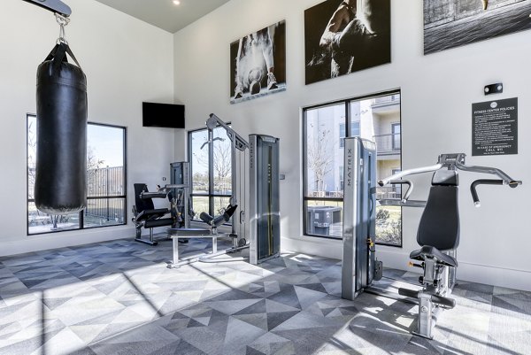 State-of-the-art fitness center with cardio machines at Moderno Apartments
