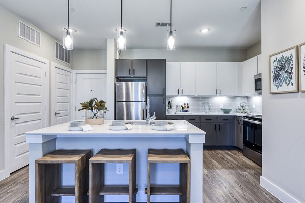 Modern kitchen with stainless steel appliances at Moderno Apartments