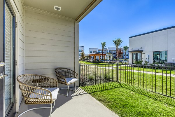 Patio with stylish seating and greenery at Moderno Apartments