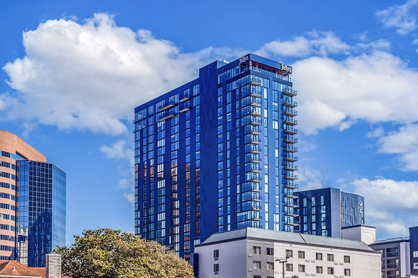 Fallyn Apartments: Modern luxury apartment with lush landscaping in suburban setting