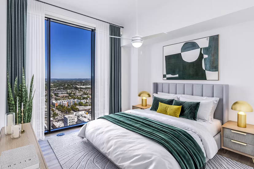 Modern bedroom with king-sized bed and large windows at Fallyn Apartments