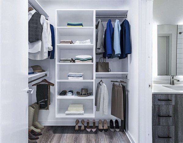 Bedroom closet with custom shelving at Fallyn Apartments: Luxury storage solutions in spacious Greystar community