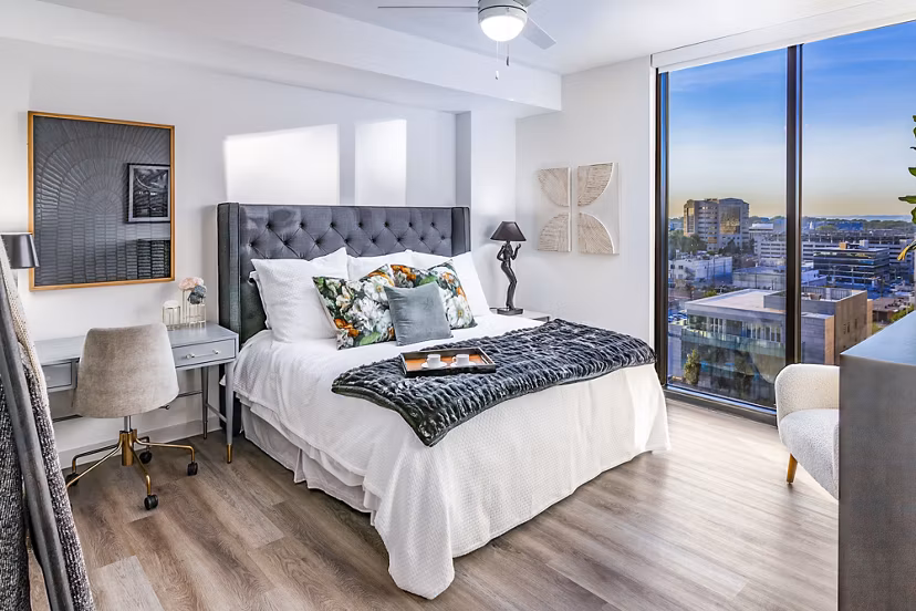 Modern bedroom with elegant decor at Fallyn Apartments: cozy luxury living space featuring chic furnishings and ambient lighting