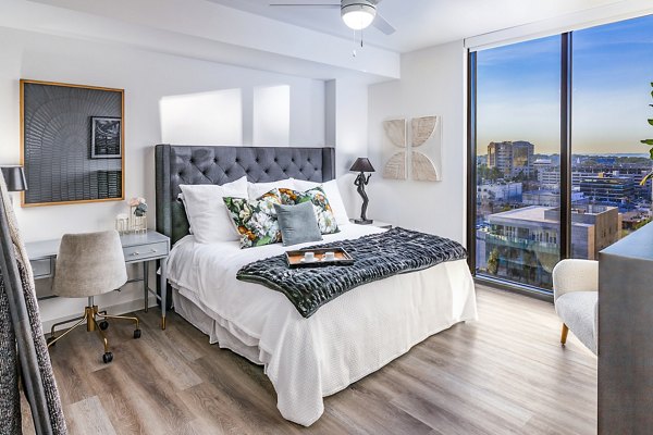 Modern bedroom with elegant decor at Fallyn Apartments: cozy luxury living space featuring chic furnishings and ambient lighting