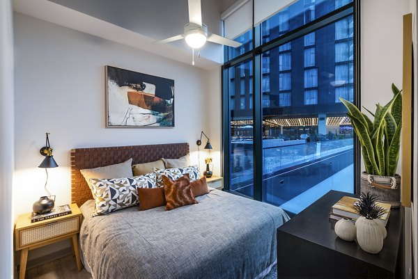 Cozy bedroom with modern decor at Fallyn Apartments, offering luxury living spaces and premium amenities in a prime location