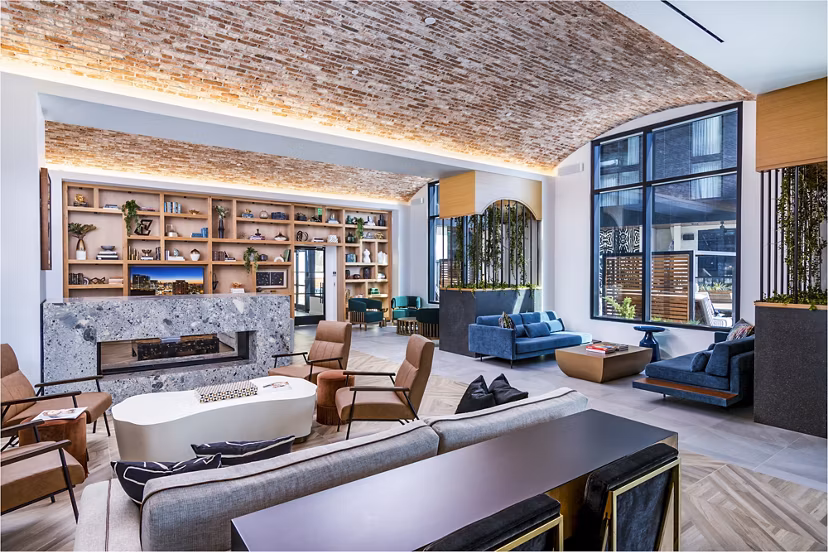 Clubhouse with stylish lounge and modern decor at Fallyn Apartments, luxury living spaces offered by Greystar
