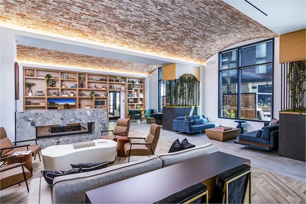 Clubhouse with stylish lounge and modern decor at Fallyn Apartments, luxury living spaces offered by Greystar