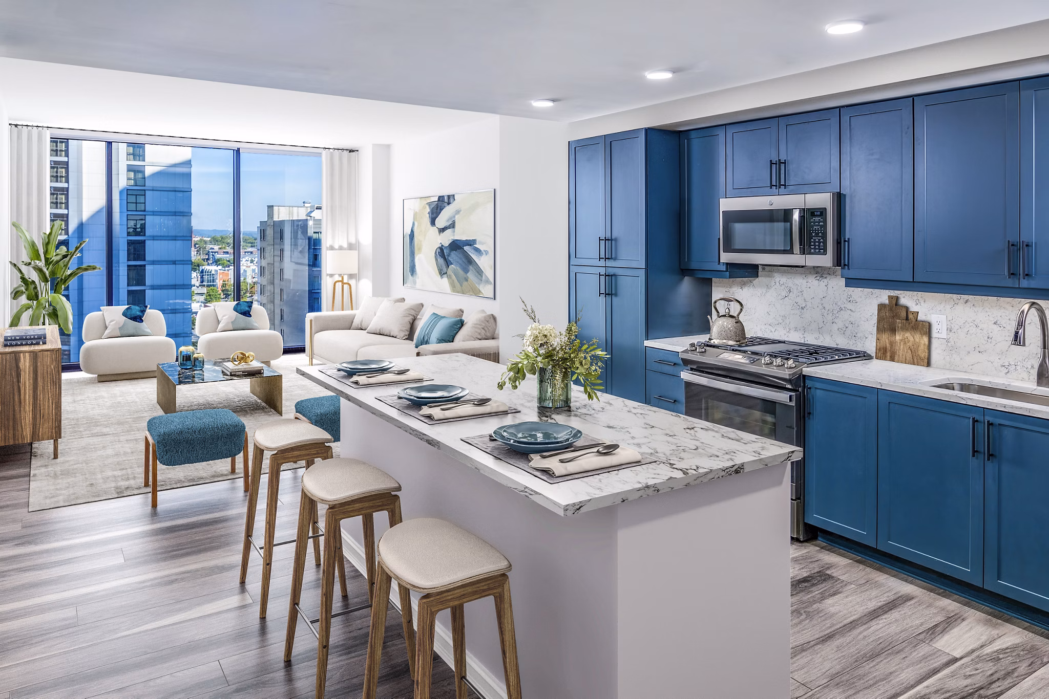 Modern kitchen with stainless steel appliances and quartz countertops in Fallyn Apartments