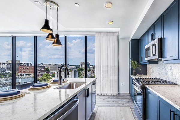Modern kitchen with sleek cabinetry and stainless steel appliances in Fallyn Apartments, offering a luxurious living experience