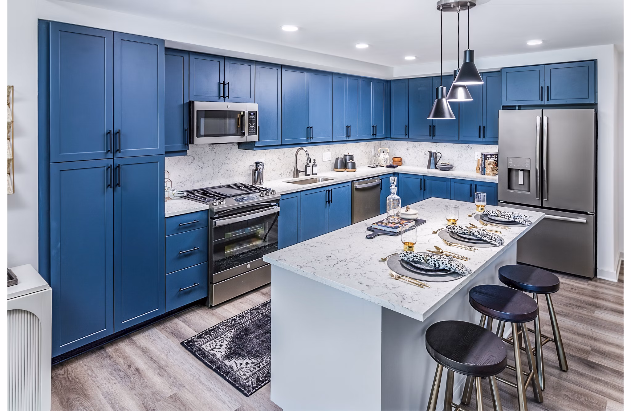 Modern kitchen with stainless steel appliances at Fallyn Apartments