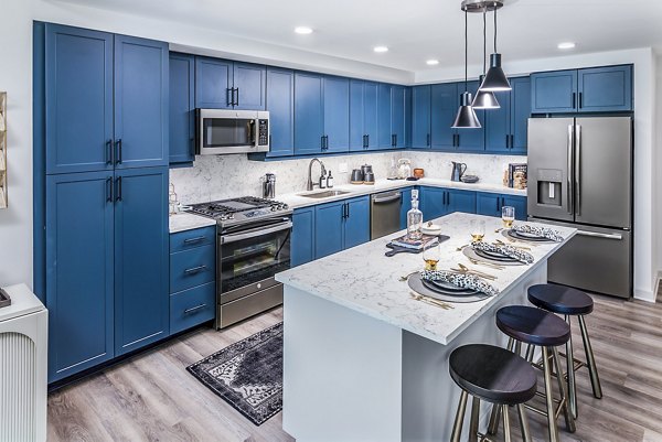 Modern kitchen with stainless steel appliances at Fallyn Apartments