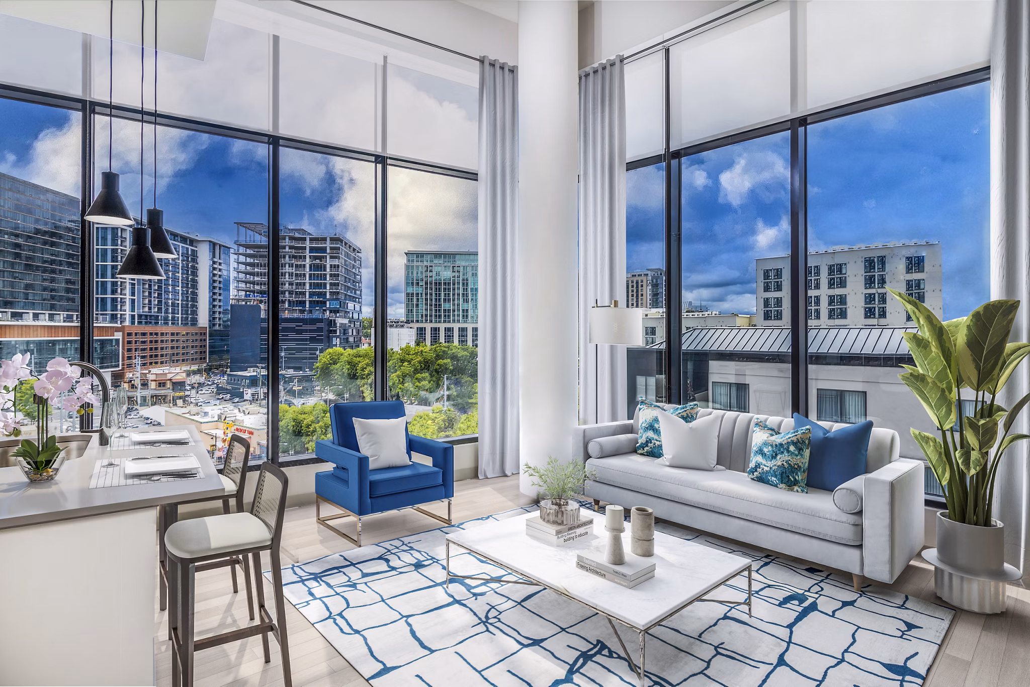 Modern living room with sleek furniture and large windows at Fallyn Apartments