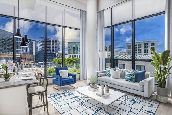 Modern living room with sleek furniture and large windows at Fallyn Apartments