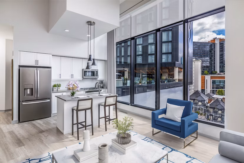 Spacious living room with modern furnishings at Fallyn Apartments