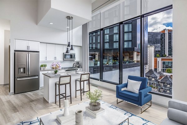 Spacious living room with modern furnishings at Fallyn Apartments