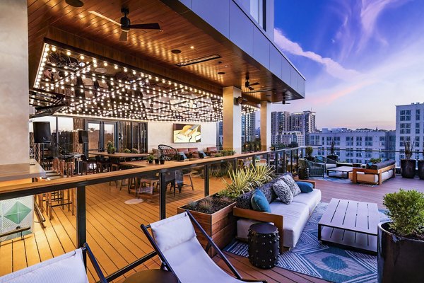 Private patio with modern furniture at Fallyn Apartments offering views of Greystar luxury surroundings