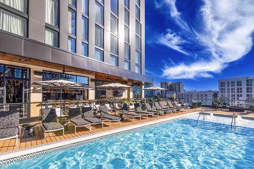Resort-style pool with lounge chairs at Fallyn Apartments offering luxury living in Greystar community