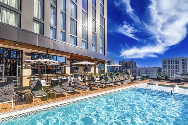 Resort-style pool with lounge chairs at Fallyn Apartments offering luxury living in Greystar community