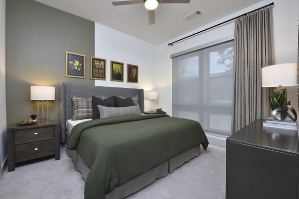 Cozy bedroom with modern decor at The Flats at West Alabama Apartments