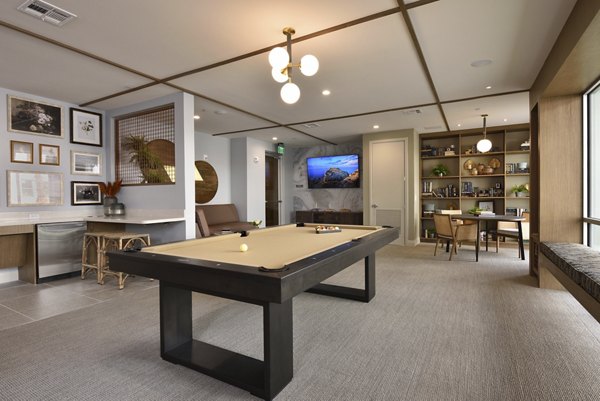 Clubhouse featuring sleek modern design and cozy seating at The Flats at West Alabama Apartments
