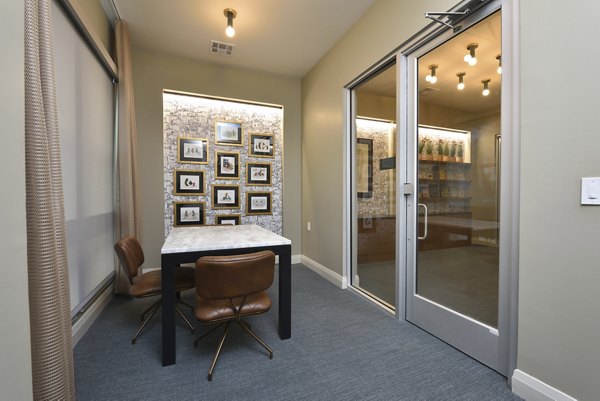 Clubhouse featuring stylish seating and flat-screen TVs at The Flats at West Alabama Apartments