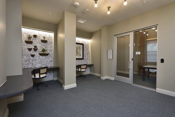 Clubhouse with modern seating and entertainment area at The Flats at West Alabama Apartments