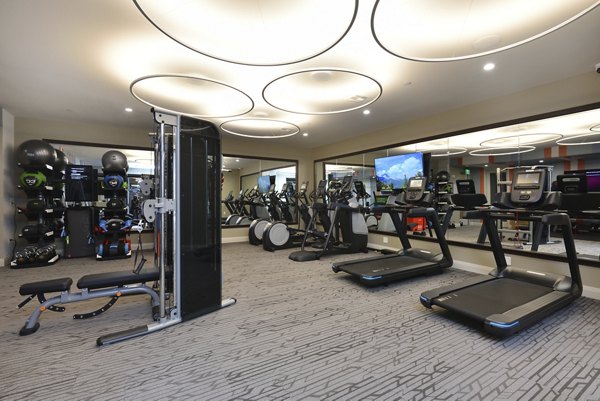 State-of-the-art fitness center at The Flats at West Alabama Apartments, featuring modern equipment and spacious workout areas
