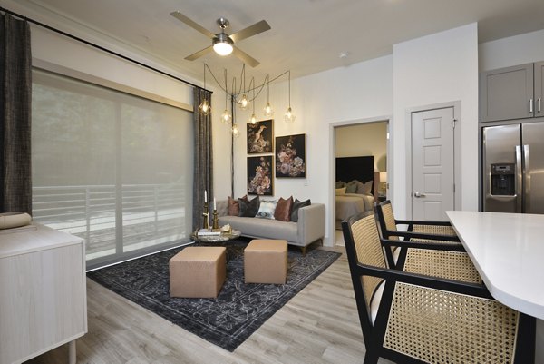 Modern kitchen with stainless steel appliances in The Flats at West Alabama Apartments