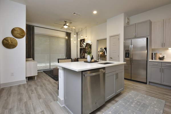 Modern kitchen featuring sleek countertops and stainless steel appliances at The Flats at West Alabama Apartments