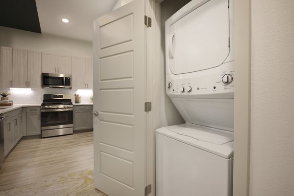 Laundry room at The Flats at  West Alabama Apartments