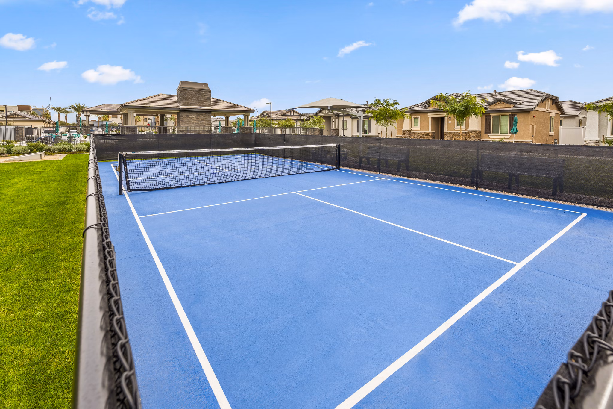 Modern tennis court at Vlux at Peoria Heights Apartments offers recreational opportunities for residents