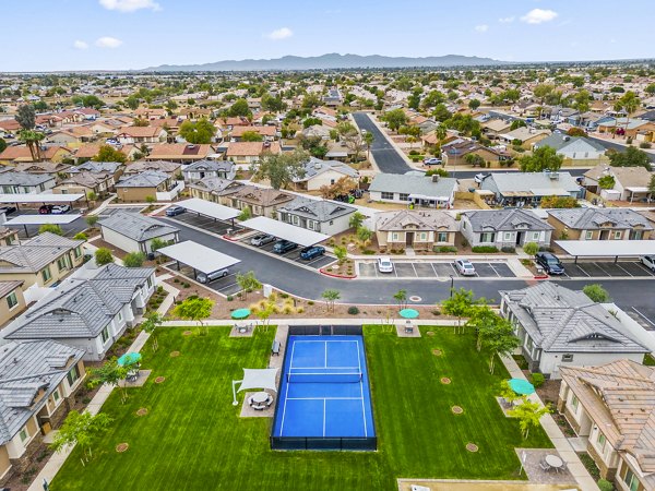 Tennis court with lush surroundings at Vlux at Peoria Heights Apartments