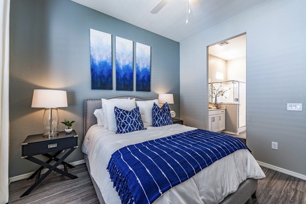 Cozy bedroom with modern decor at Vlux at Queen Creek Apartments