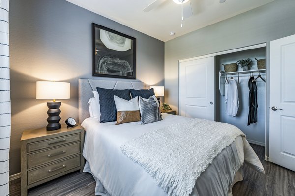 Contemporary bedroom with stylish decor at Vlux at Queen Creek Apartments