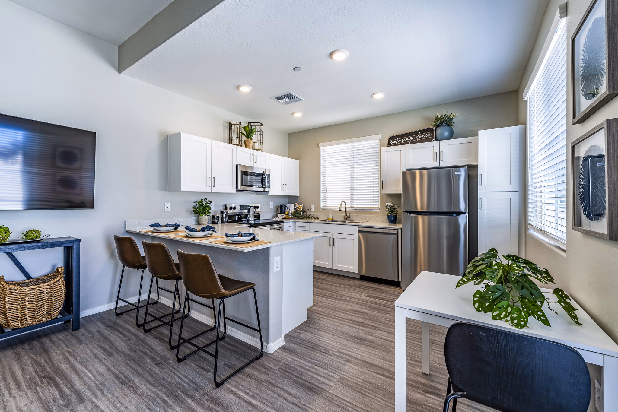 Modern kitchen with stainless steel appliances at Vlux at Queen Creek Apartments