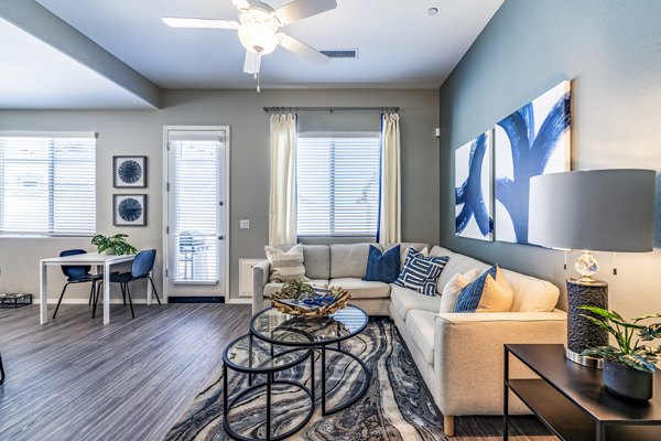 Spacious living room with modern furnishings at Vlux at Queen Creek Apartments
