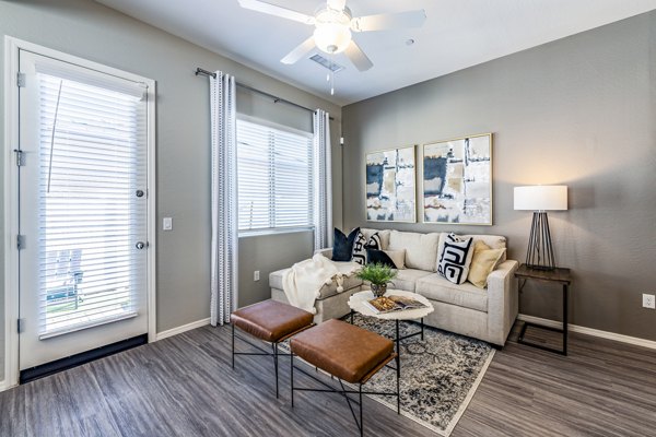 Modern living room with plush seating and stylish dÃ©cor at Vlux at Queen Creek Apartments, featuring luxury design elements