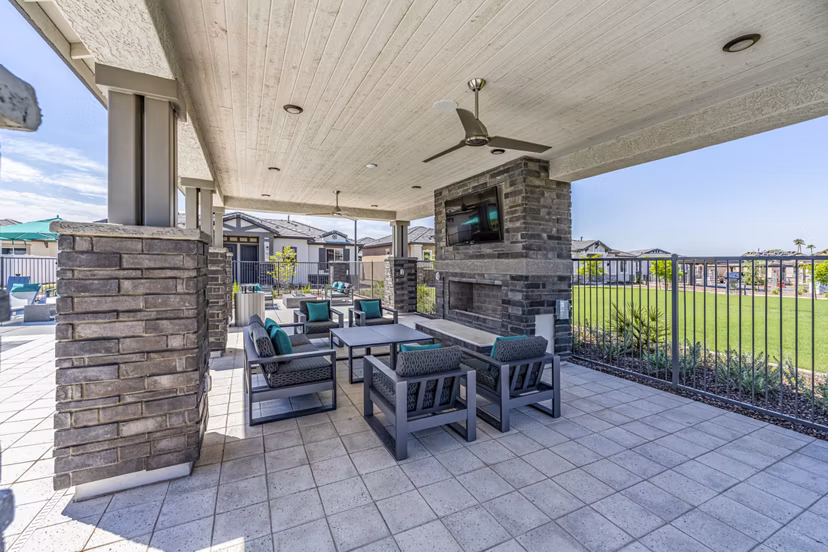 Cozy fire pit and patio at Vlux at Queen Creek Apartments, perfect for outdoor relaxation and gatherings
