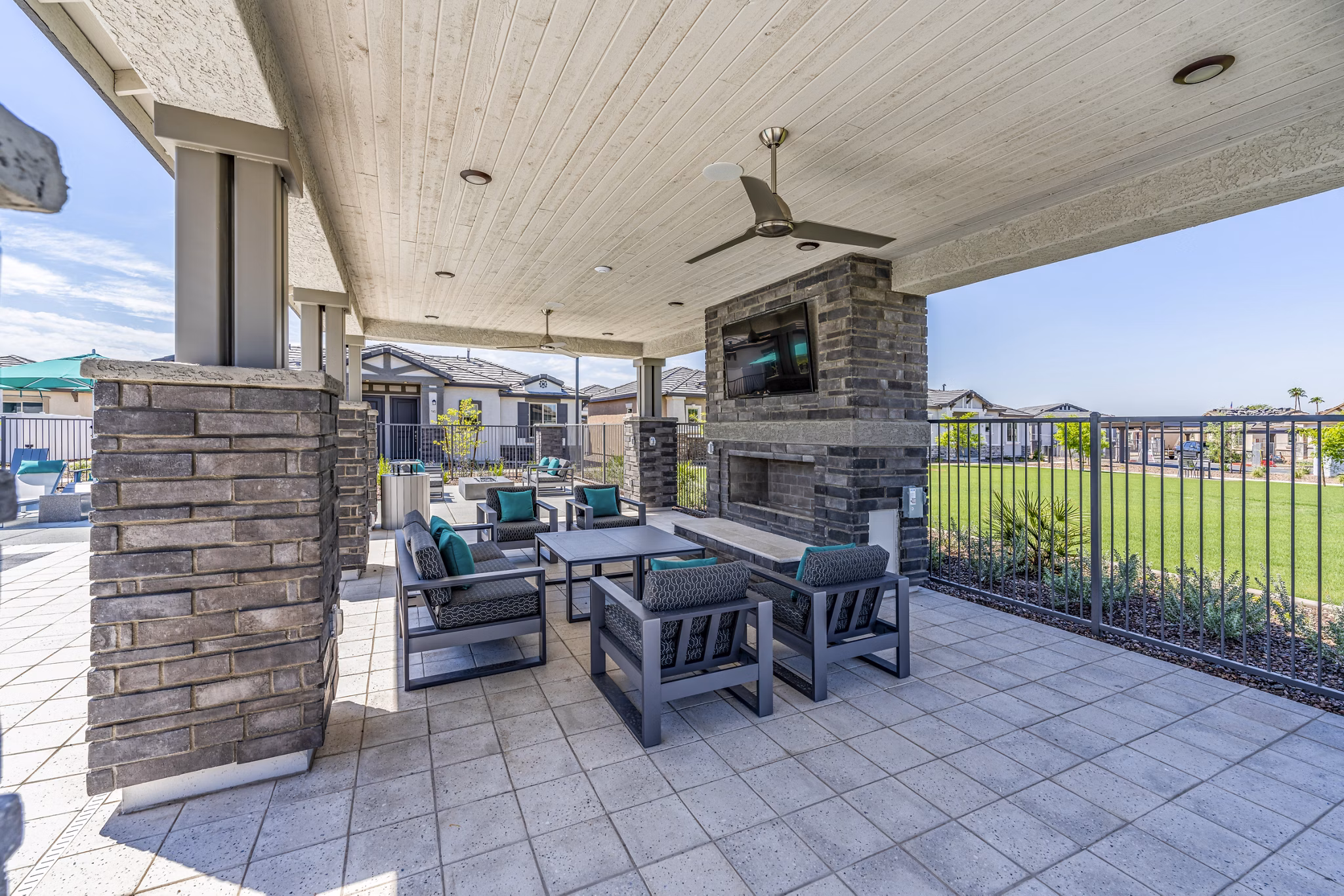 Cozy fire pit and patio at Vlux at Queen Creek Apartments, perfect for outdoor relaxation and gatherings