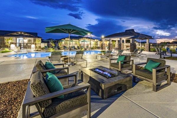 Cozy fire pit and patio area at Vlux at Queen Creek Apartments, perfect for relaxing outdoor gatherings