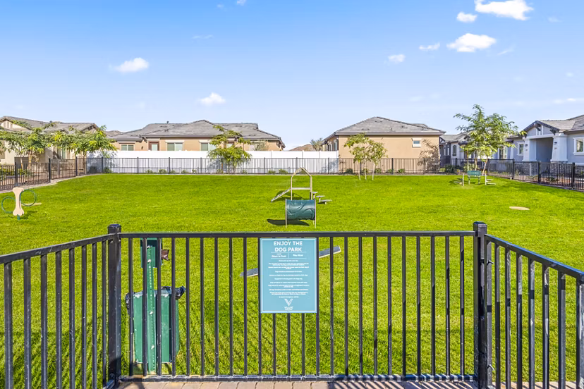Expansive dog park with lush landscaping at Vlux at Queen Creek Apartments