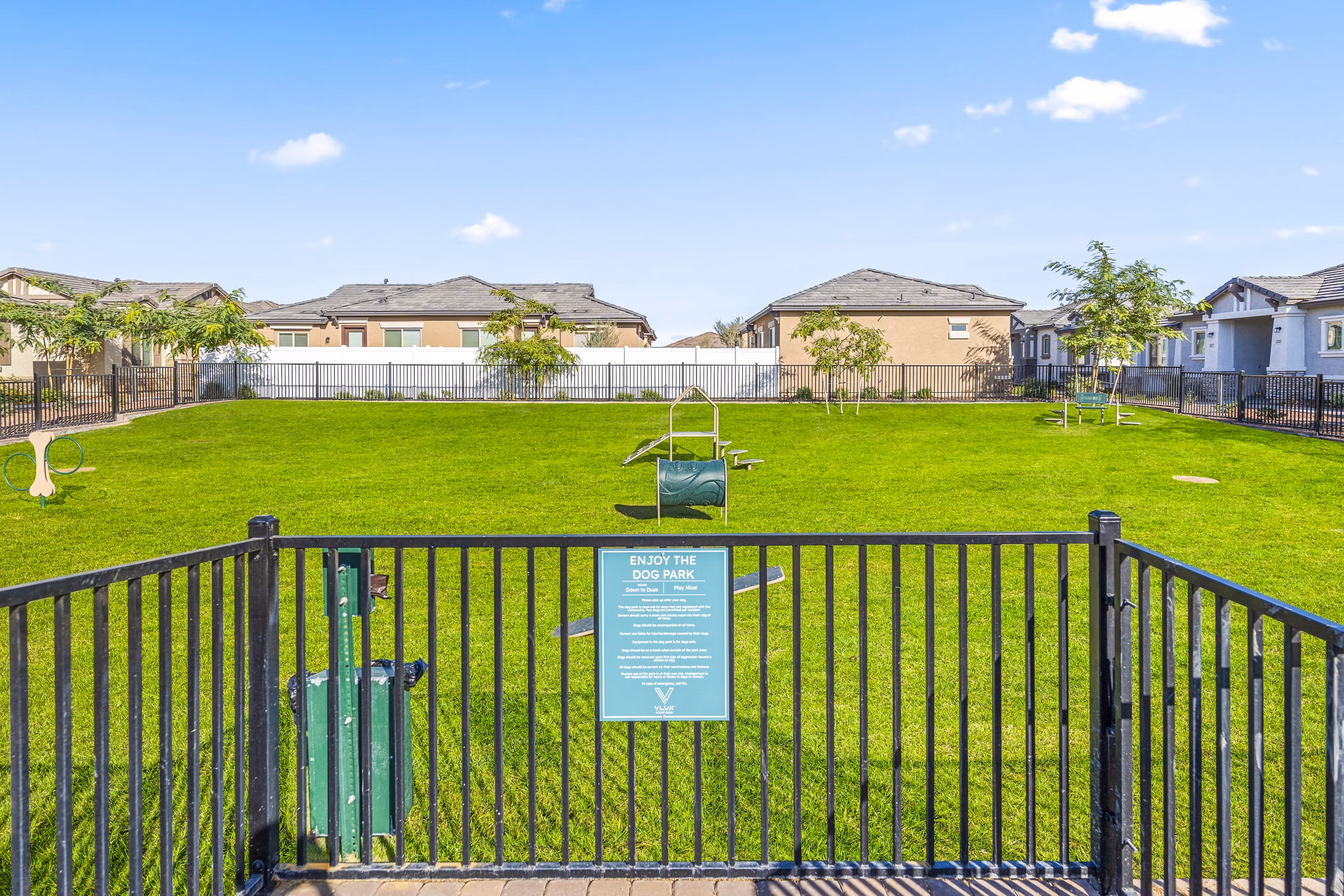 Expansive dog park with lush landscaping at Vlux at Queen Creek Apartments