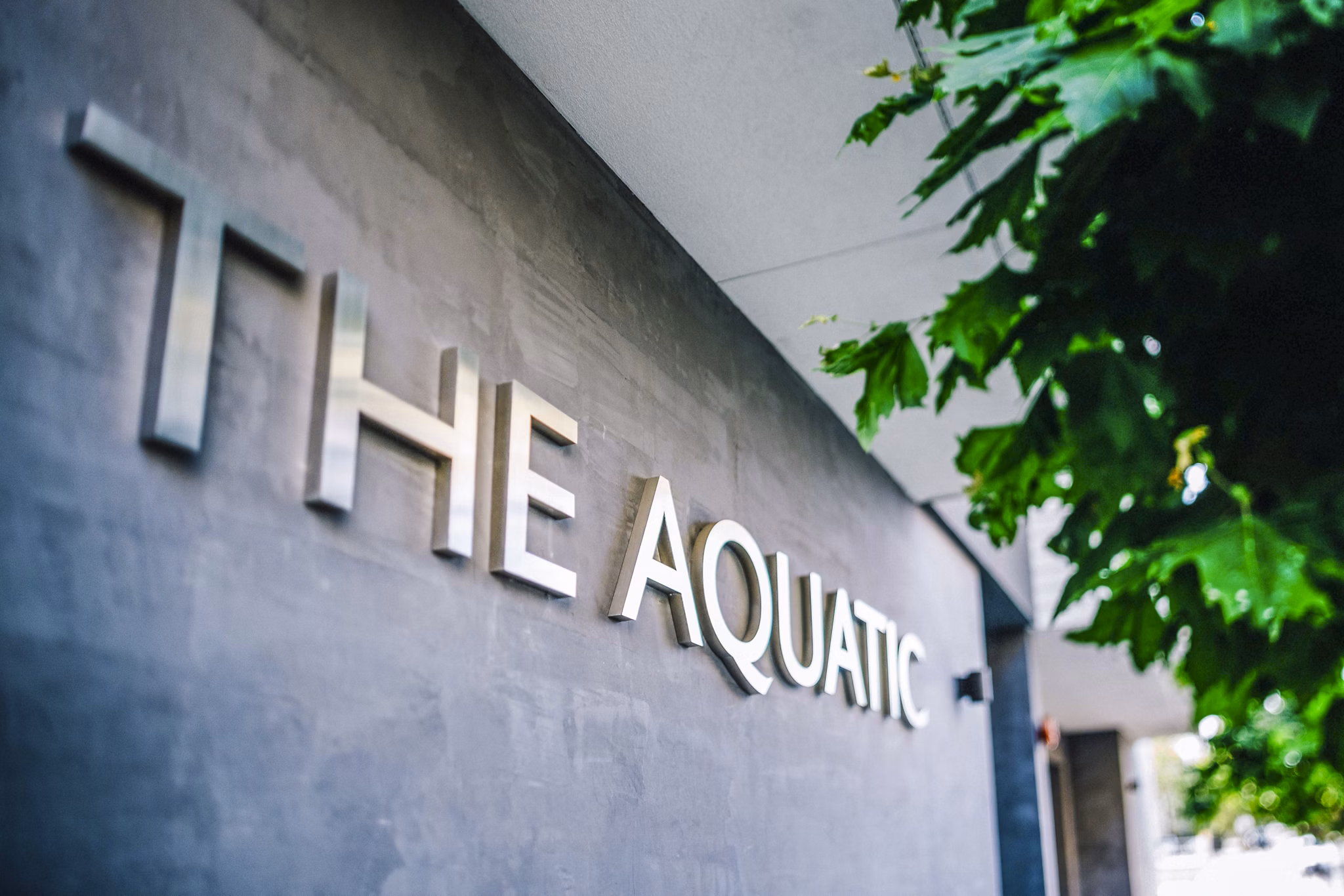 Signage at Aquatic I Apartments: Modern entrance sign at a luxury apartment community