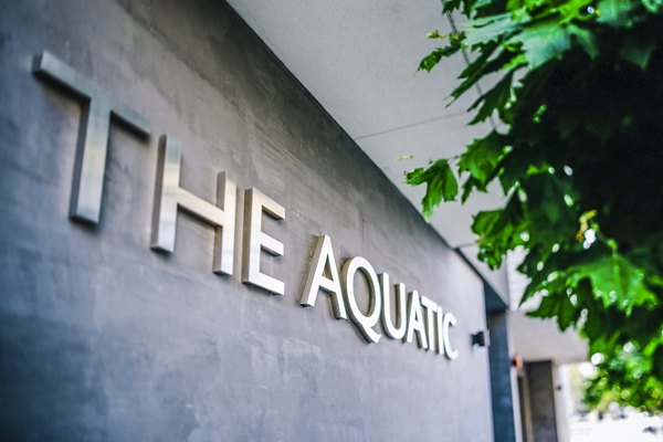 Signage at Aquatic I Apartments: Modern entrance sign at a luxury apartment community