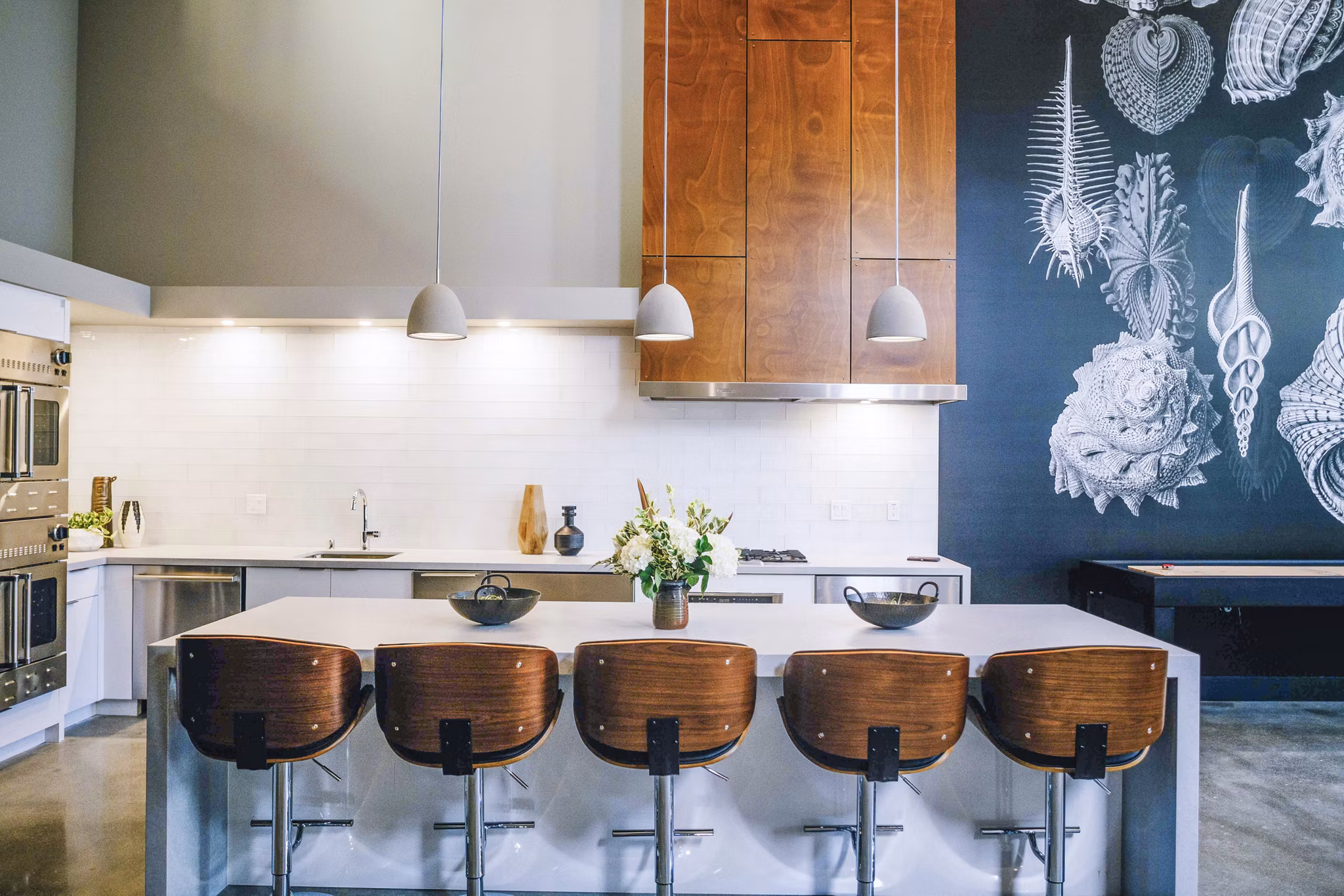 Aquatic I Apartments: Modern clubhouse kitchen featuring sleek countertops and stainless steel appliances