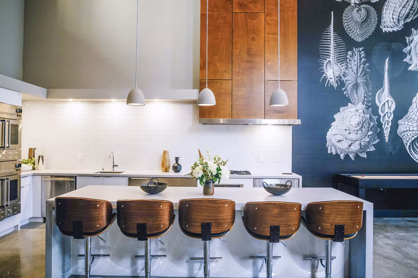 Aquatic I Apartments: Modern clubhouse kitchen featuring sleek countertops and stainless steel appliances