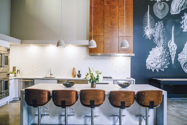 Aquatic I Apartments: Modern clubhouse kitchen featuring sleek countertops and stainless steel appliances