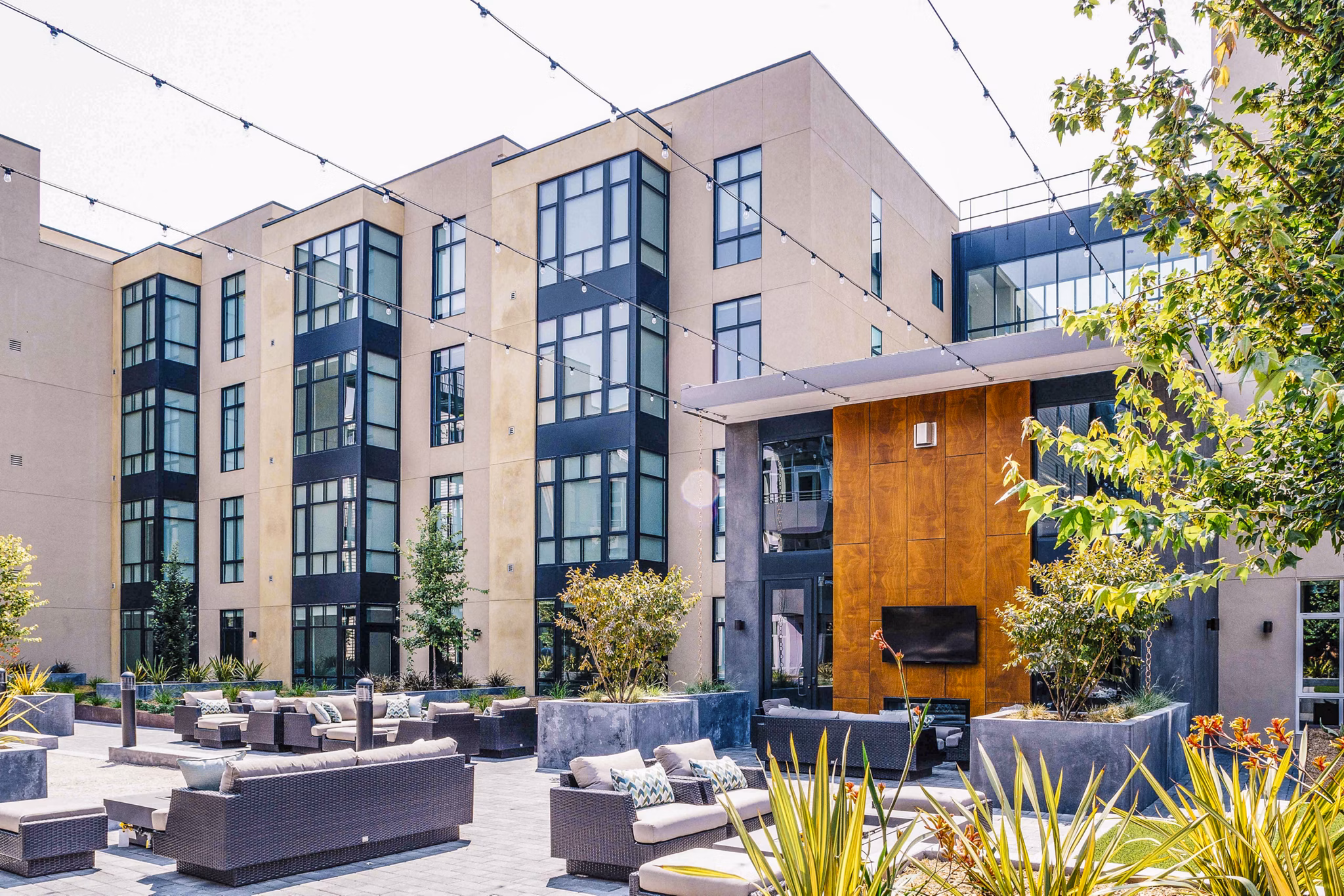 Outdoor patio with seating and greenery at Aquatic I Apartments, offering a serene environment