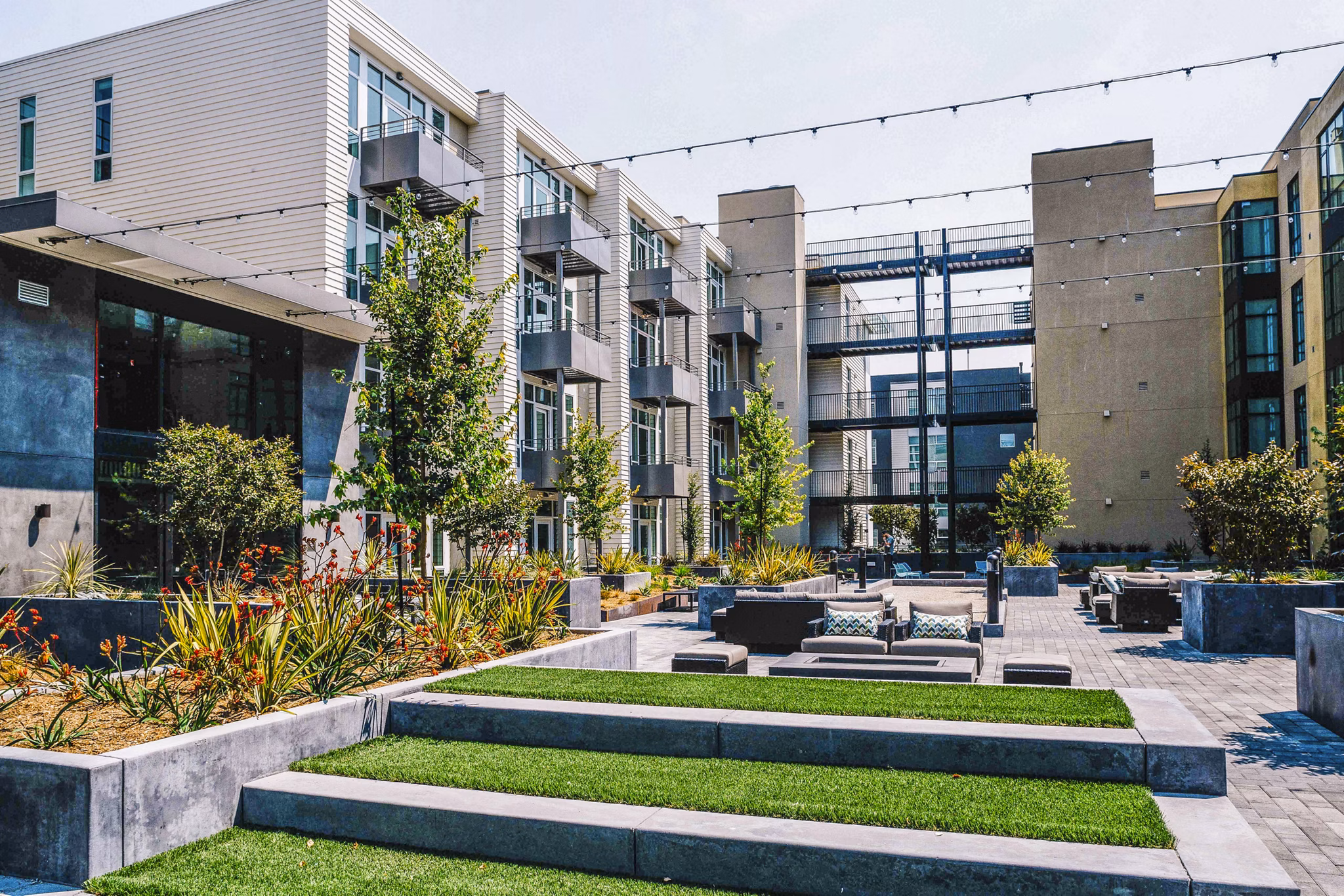 Cozy patio with modern furnishings at Aquatic I Apartments, perfect for outdoor relaxation in a luxury setting